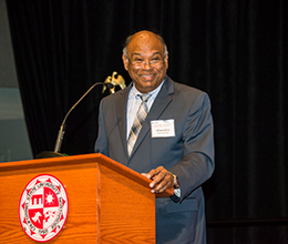 The dean of the college of business speaks at an event 