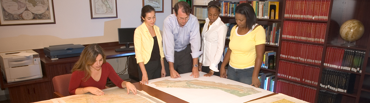 students study a map in the library