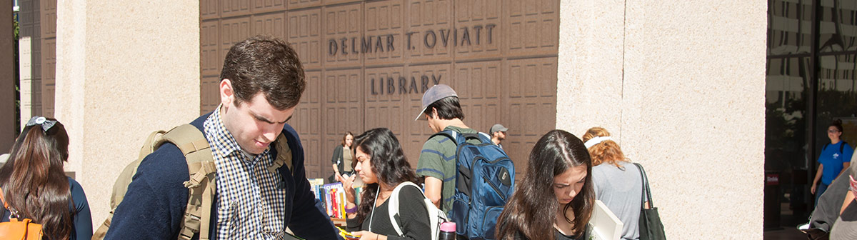 Students sit and talk inside the oviatt Library 