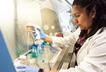 A Female Student working in a lab doing experiements