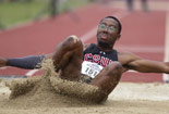 Student landing in sand after completing a long jump