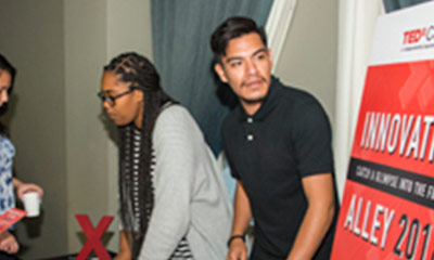 Two students talking to others about their presention