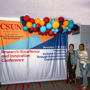 students at conference backdrop